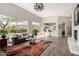 Open-concept living room with modern decor, neutral colors, and a connection to the kitchen at 32627 N 70Th St, Scottsdale, AZ 85266