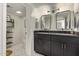 Modern bathroom features a double sink vanity, matte black fixtures, and honeycomb tile floors at 334 W Medlock Dr # D102, Phoenix, AZ 85013