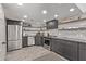 Updated kitchen featuring stainless steel appliances, modern cabinetry, and stylish backsplash at 334 W Medlock Dr # D102, Phoenix, AZ 85013