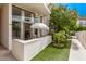 Private outdoor patio with turf, seating, and mature tree at 334 W Medlock Dr # D102, Phoenix, AZ 85013