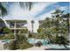 Community swimming pool surrounded by lush landscaping and palm trees at 334 W Medlock Dr # D102, Phoenix, AZ 85013