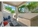 A fenced-in backyard and patio are shaded by trees and feature patio furniture at 3365 W Thude Dr, Chandler, AZ 85226