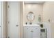 Modern bathroom with white vanity, round mirror, and ample storage space at 3365 W Thude Dr, Chandler, AZ 85226