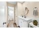 Updated bathroom with white cabinets, tile backsplash, and modern fixtures at 3365 W Thude Dr, Chandler, AZ 85226