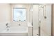 Bright bathroom featuring a shower and tub combination with tiled walls at 3365 W Thude Dr, Chandler, AZ 85226