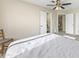 Bright bedroom with neutral paint, carpet, ceiling fan and view of the en suite bathroom at 3365 W Thude Dr, Chandler, AZ 85226