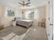Sunlit bedroom with neutral carpet, ceiling fan, and two bright windows at 3365 W Thude Dr, Chandler, AZ 85226