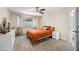 Cozy bedroom with a ceiling fan, neutral walls, and a large window at 3365 W Thude Dr, Chandler, AZ 85226