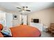 Well-lit bedroom featuring a ceiling fan, neutral walls, carpet floors, and large dresser at 3365 W Thude Dr, Chandler, AZ 85226