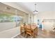 The dining room features lots of natural light, a wooden table and adjacent staircase at 3365 W Thude Dr, Chandler, AZ 85226