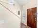 Inviting entryway features a wood door and stairwell with wood handrail at 3365 W Thude Dr, Chandler, AZ 85226