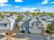 Bright aerial view of the two-story home with blue trim, neutral exterior, landscaping, and a two car garage at 3365 W Thude Dr, Chandler, AZ 85226