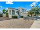 A well-maintained two-story home with an attached garage, a gravel yard, and colorful landscaping at 3365 W Thude Dr, Chandler, AZ 85226