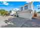 Exterior of a two-story home with an attached garage, featuring a gravel yard and mature landscaping at 3365 W Thude Dr, Chandler, AZ 85226