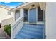 The covered front porch features a blue door and stairs, with landscaped plants on either side at 3365 W Thude Dr, Chandler, AZ 85226