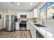 Bright kitchen boasts stainless steel appliances, white cabinetry, and plenty of counter space for meal preparation at 3365 W Thude Dr, Chandler, AZ 85226