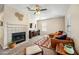 Spacious living room featuring a fireplace, leather sectional, and entertainment center at 3365 W Thude Dr, Chandler, AZ 85226