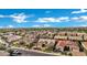 Expansive aerial view of a neighborhood showcasing well-maintained homes under a bright, partly cloudy sky at 3552 E Dogwood Dr, Chandler, AZ 85286