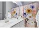 Bright bathroom with white vanity with double sinks and colorful shower curtain at 3552 E Dogwood Dr, Chandler, AZ 85286