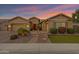 Inviting single-story home with well-manicured landscaping and a charming walkway at dusk at 3552 E Dogwood Dr, Chandler, AZ 85286