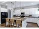 Modern kitchen with granite countertops, stainless steel appliances, large island, and bar stool seating at 3552 E Dogwood Dr, Chandler, AZ 85286