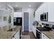 Bright kitchen with granite countertops, stainless appliances, white cabinetry, and dark wood flooring at 3552 E Dogwood Dr, Chandler, AZ 85286