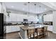 Stylish kitchen showcasing white cabinets, stainless appliances, granite countertops, and pendant lighting at 3552 E Dogwood Dr, Chandler, AZ 85286