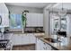 Bright kitchen features granite countertops, white cabinets, stainless steel appliances, and under cabinet lighting at 3552 E Dogwood Dr, Chandler, AZ 85286