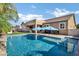 Inviting backyard pool with blue umbrellas, creating a refreshing oasis for outdoor relaxation and entertainment at 3552 E Dogwood Dr, Chandler, AZ 85286
