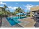 Backyard pool with stone surround, featuring a pair of shade umbrellas and a barbeque area, all set in a private outdoor oasis at 3552 E Dogwood Dr, Chandler, AZ 85286