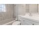 This bathroom features updated tile surround, bright vanity, and neutral walls at 3824 N 8Th Ave, Phoenix, AZ 85013