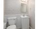 This powder room features white vanity and painted brick, with bright lighting at 3824 N 8Th Ave, Phoenix, AZ 85013