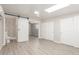 Spacious bedroom with wood-look flooring, recessed lighting, and en suite bath with barn door at 3824 N 8Th Ave, Phoenix, AZ 85013