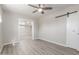 Open bedroom with wood-look flooring, ceiling fan, and a modern sliding barn door at 3824 N 8Th Ave, Phoenix, AZ 85013