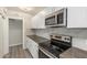 Modern kitchen featuring stainless steel appliances, sleek countertops, and white cabinets at 3824 N 8Th Ave, Phoenix, AZ 85013