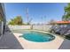 Sparkling pool with concrete surround and artificial turf, all enclosed by a block wall for privacy at 3824 N 8Th Ave, Phoenix, AZ 85013