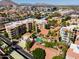 Stunning aerial view of a complex featuring lush landscaping, a refreshing pool, and well-maintained apartment buildings at 4200 N Miller Rd # 228, Scottsdale, AZ 85251