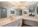 Bright bathroom featuring a double vanity, ample counter space, and a mirrored wall at 4200 N Miller Rd # 228, Scottsdale, AZ 85251