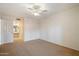 Neutral bedroom with ceiling fan and access to a bathroom, ensuring a functional space at 4200 N Miller Rd # 228, Scottsdale, AZ 85251