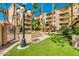 Beautiful condominium complex featuring lush landscaping, manicured lawns and courtyard at 4200 N Miller Rd # 228, Scottsdale, AZ 85251
