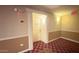 Hallway featuring unit 228 shows carpeted floors, tan walls and a white door with ornate trimming at 4200 N Miller Rd # 228, Scottsdale, AZ 85251