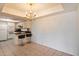 Bright kitchen with white cabinetry and a breakfast bar connects to a dining area, great for entertaining at 4200 N Miller Rd # 228, Scottsdale, AZ 85251