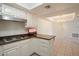 Clean kitchen with white cabinets, a breakfast bar, and essential appliances provides functionality at 4200 N Miller Rd # 228, Scottsdale, AZ 85251