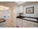 Functional kitchen with a double sink, white cabinetry and a dishwasher offer simplicity at 4200 N Miller Rd # 228, Scottsdale, AZ 85251