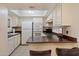 Bright kitchen with white cabinetry, ample counter space, and a breakfast bar provides convenience at 4200 N Miller Rd # 228, Scottsdale, AZ 85251