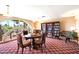 Cozy library room with a round table, chairs, bookshelf, and arched window offering a neighborhood view at 4200 N Miller Rd # 228, Scottsdale, AZ 85251