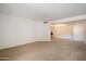 Expansive living room with neutral carpeting and an open layout provides a versatile space at 4200 N Miller Rd # 228, Scottsdale, AZ 85251