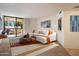 Bright living room boasts an oversized sectional sofa, outdoor balcony access, and neutral-toned walls at 4200 N Miller Rd # 228, Scottsdale, AZ 85251