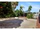 View of the gazebo, citrus trees, and outdoor kitchen in the backyard at 43232 W Magnolia Rd, Maricopa, AZ 85138