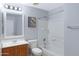 Well-lit bathroom featuring vanity, toilet and bathtub with shower combo at 43232 W Magnolia Rd, Maricopa, AZ 85138